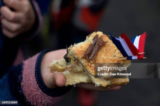 Piece of the hare pie is thrown to the crowd after being carried through the village on April 17, 2017 in Hallaton, England. Hallaton hosts the Hare...