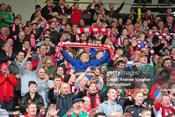 Lincoln City fans celebrate at the end of the Vanarama National League match between Gateshead and Lincoln City at on April 17, 2017 in Gateshead,...