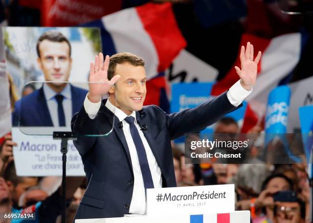 French presidential election candidate from the centrist 'En Marche!' political party, Emmanuel Macron waves to supporters during his political...