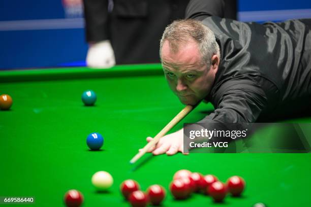 John Higgins of Scotland plays a shot during his first round match against Martin Gould of England on day three of Betfred World Championship 2017 at...