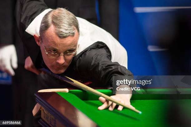 Martin Gould of England plays a shot during his first round match against John Higgins of Scotland on day three of Betfred World Championship 2017 at...