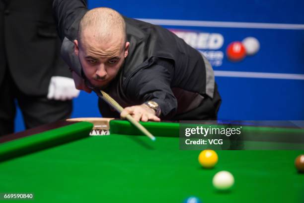 Luca Brecel of Belgium plays a shot during his first round match against Marco Fu of Chinese Hong Kong on day three of Betfred World Championship...