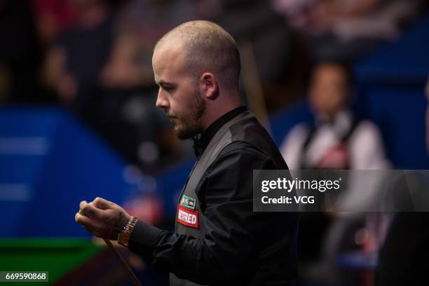 Luca Brecel of Belgium reacts during his first round match against Marco Fu of Chinese Hong Kong on day three of Betfred World Championship 2017 at...