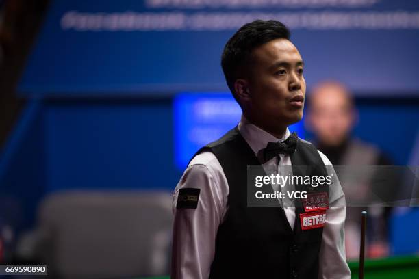 Marco Fu of Chinese Hong Kong reacts during his first round match against Luca Brecel of Belgium on day three of Betfred World Championship 2017 at...