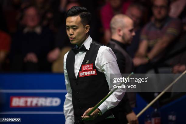 Marco Fu of Chinese Hong Kong reacts during his first round match against Luca Brecel of Belgium on day three of Betfred World Championship 2017 at...