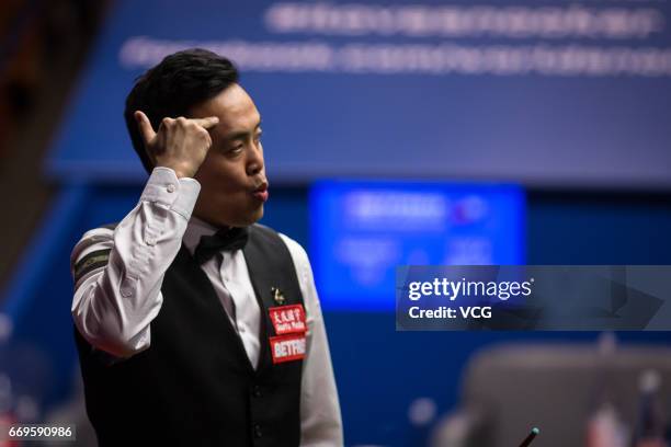 Marco Fu of Chinese Hong Kong reacts during his first round match against Luca Brecel of Belgium on day three of Betfred World Championship 2017 at...