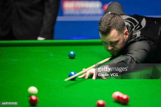 Jimmy Robertson of England plays a shot during his first round match against Mark Allen of Northern Ireland on day three of Betfred World...