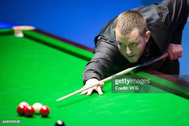 Mark Allen of Northern Ireland plays a shot during his first round match against Jimmy Robertson of England on day three of Betfred World...