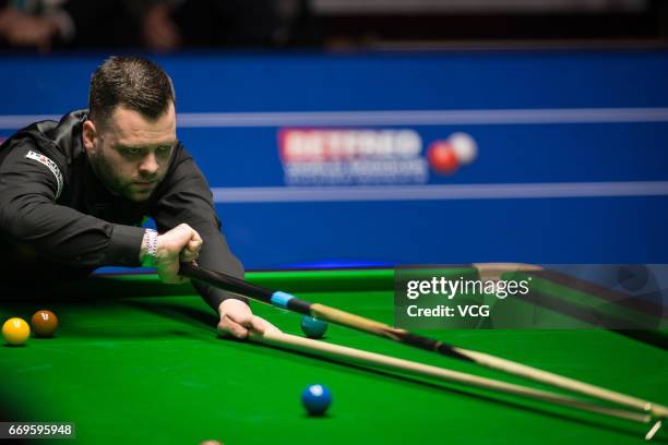 Jimmy Robertson of England plays a shot during his first round match against Mark Allen of Northern Ireland on day three of Betfred World...