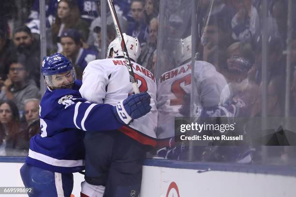 Toronto Maple Leafs center Nazem Kadri checks Matt Niskanen as the Toronto Maple Leafs play the Washington Capitals in game three of their NHL first...