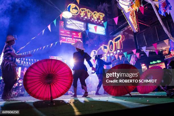 This photo taken on March 29, 2017 shows performers dancing on a stage set up in a red light district of Pattaya at an event used to highlight a push...