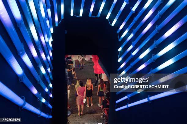 This photo taken on March 29, 2017 shows women standing in the entrance to a go go dance bar to entice customers to enter in Walking Street in...