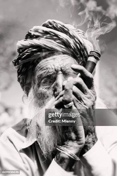 senior indian man smoking pipe real people portrait bw india - poor eyesight stock pictures, royalty-free photos & images