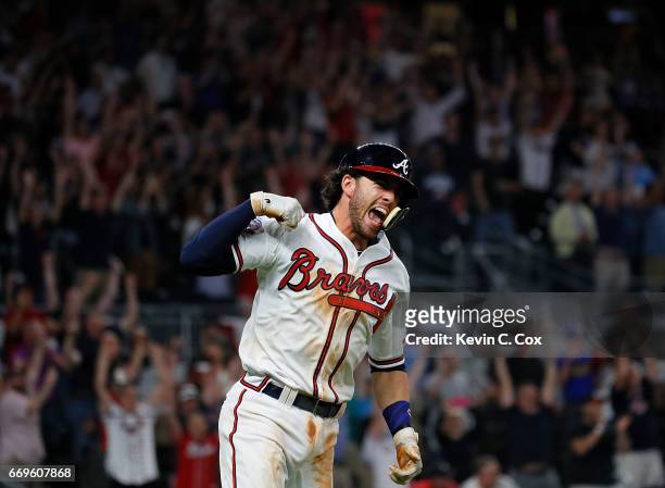 Dansby Swanson of the Atlanta Braves reacts after hitting a walk-off single to give the Braves a 5-4 win over the San Diego Padres in the ninth...