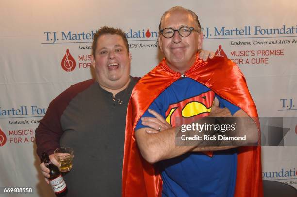 Comedian Ralphie May and Warner Music Nashville Chairman/CEO John Esposito take photos at the T.J. Martell roast of Warner Music Nashville...