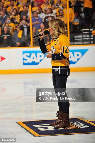 Carrie Underwood sings the national anthem prior to Game Three of the Western Conference First Round during the 2017 NHL Stanley Cup Playoffs at...