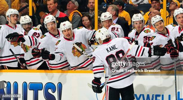 Patrick Kane of the Chicago Blackhawks is congratulated by teammates after scoring a goal against the Nashville Predators during the second period in...