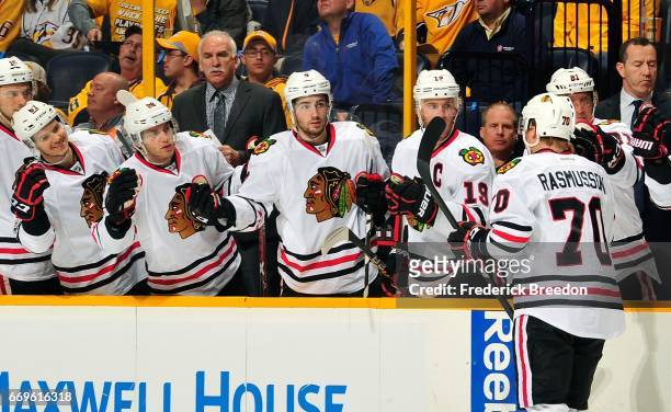 Dennis Rasmussen of the Chicago Blackhawks is congratulated by teammates after scoring the first goal of the game against the Nashville Predators...