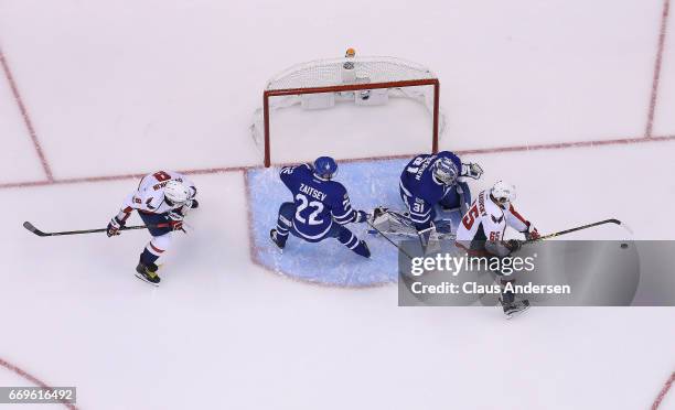 Andre Burakovsky of the Washington Capitals tries to get a puck at Frederik Andersen of the Toronto Maple Leafs in Game Three of the Eastern...