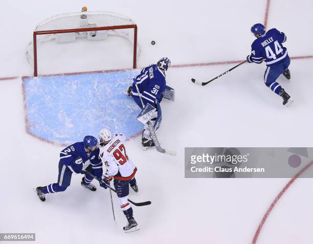 Morgan Rielly of the Toronto Maple Leafs grabs the puck for teammate Frederik Andersen against the Washington Capitals in Game Three of the Eastern...
