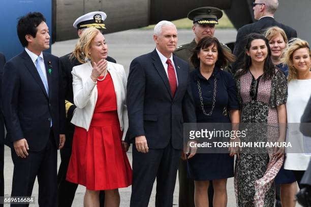 Vice President Mike Pence , his wife Karen and two daughters Audrey and Charlotte pose for photographs after arriving at the US naval air facility in...