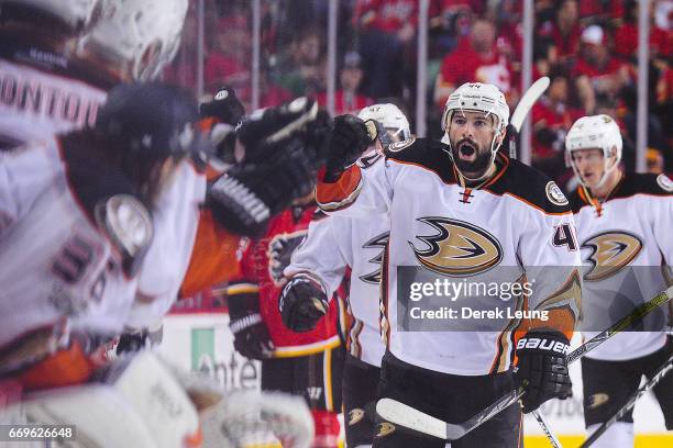 Nate Thompson of the Anaheim Ducks celebrates with the bench after scoring his team's third goal against the Calgary Flames in Game Three of the...