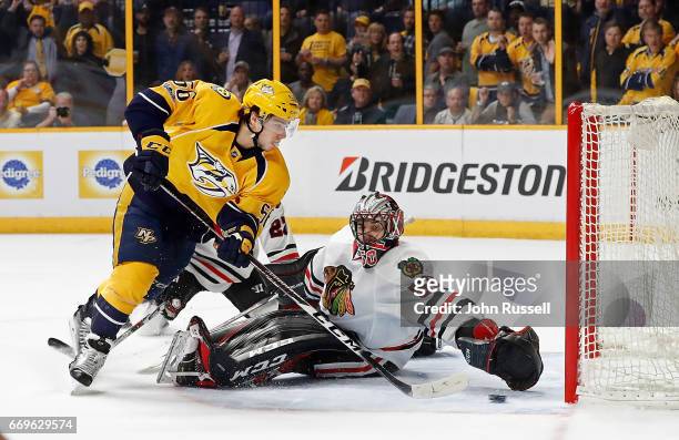 Kevin Fiala of the Nashville Predators scores the overtime game winning goal against Corey Crawford of the Chicago Blackhawks in Game Three of the...