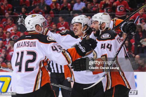 Josh Manson, Rickard Rakell, and Nate Thompson of the Anaheim Ducks celebrate the winning goal of their teammate Corey Perry against the Calgary...