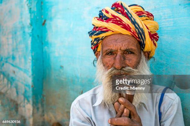 senior indian man holding his pipe real people portrait india - poor eyesight stock pictures, royalty-free photos & images