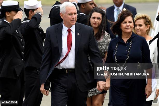 Vice President Mike Pence , his wife Karen and two daughters Audrey and Charlotte walk after arriving at the US naval air facility in Atsugi,...