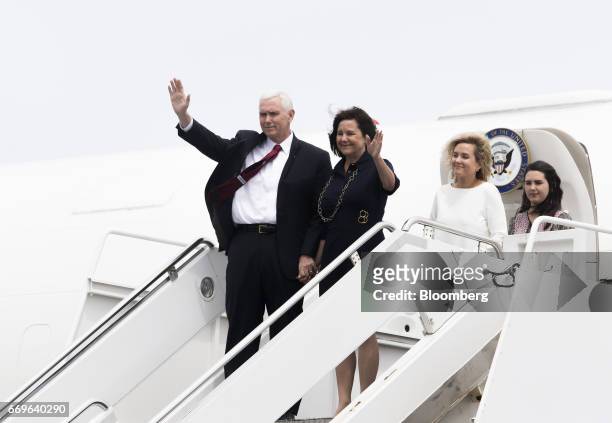 Vice President Mike Pence, left, and second lady Karen Pence, second left, wave as his daughters Audrey, second right, and Charlotte look on upon...
