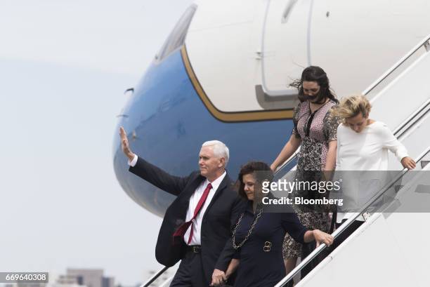 Vice President Mike Pence, left, waves as second lady Karen Pence, bottom right, and his daughters Audrey, top left, and Charlotte walk down the...