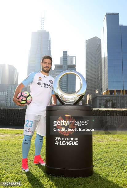 Melbourne City FC Captain Bruno Fornaroli poses with the Hyundai A-League Championship Trophy during an A-League Melbourne media opportunity at...