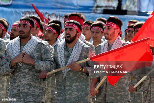 Iranian members of the Basij militia march during a parade marking the country's Army Day, on April 18 in Tehran. / AFP PHOTO / ATTA KENARE