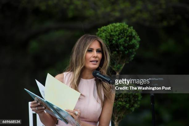 First lady Melania Trump reads to children during the 139th Easter Egg Roll on the South Lawn of the White House in Washington, DC on Monday, April...