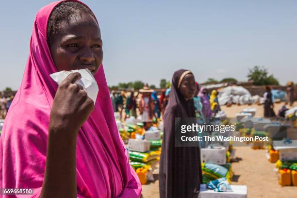 Monguno, Nigeria- Women wait for a food distribution to commence at the Government Girls Secondary School IDP camp in Monguno, Nigeria on Tuesday,...