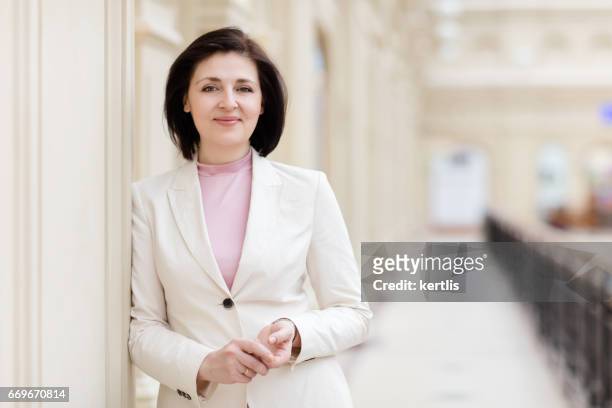 businesswoman 50 years old in a white jacket - 50 54 years imagens e fotografias de stock