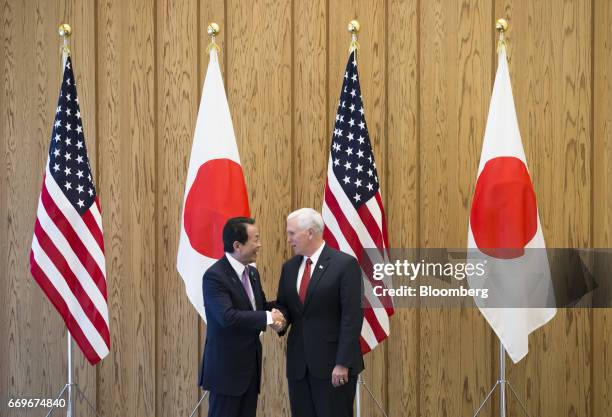 Taro Aso, Japan's deputy prime minister and finance minister, left, shakes hands with U.S. Vice President Mike Pence ahead of their U.S.-Japan...