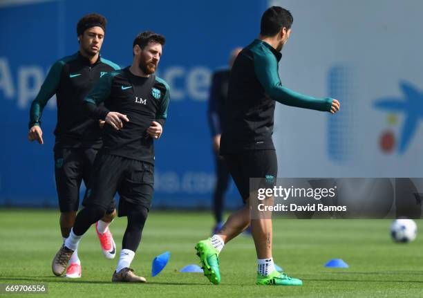 Neymar, Lionel Messi and Luis Suarez of Barcelona take part in a drill during a FC Barcelona training session on the eve of their UEFA Champions...