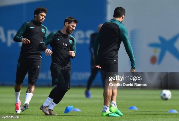Neymar, Lionel Messi and Luis Suarez of Barcelona take part in a drill during a FC Barcelona training session on the eve of their UEFA Champions...