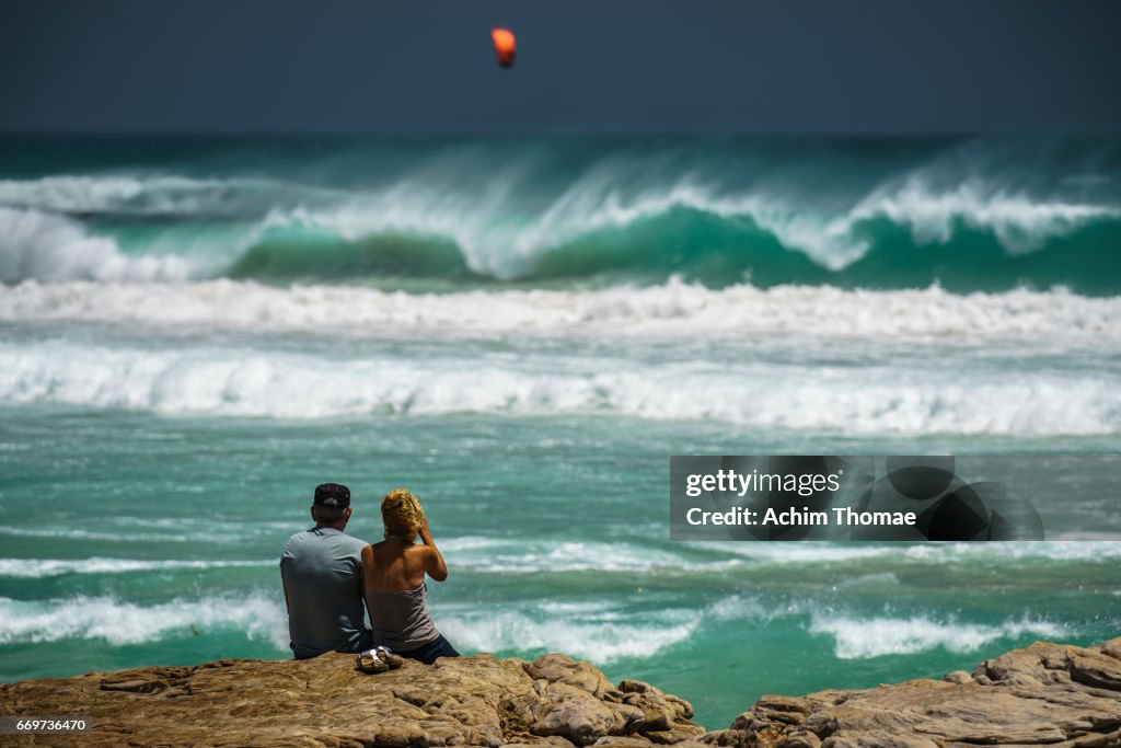 Couple watching the waves near Cape Town, South Africa