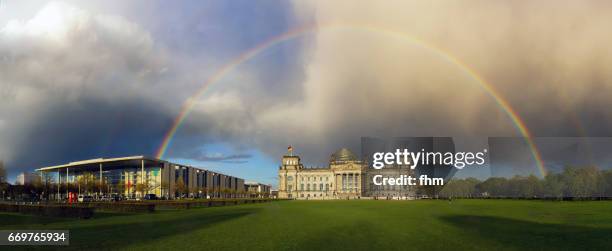 full rainbow over the reichstag (parliament building) in the german capital berlin - very rare scene - the reichstag stock pictures, royalty-free photos & images