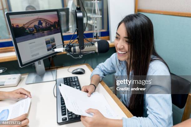 female student broadcasting from the university's radio station - jornalismo imagens e fotografias de stock