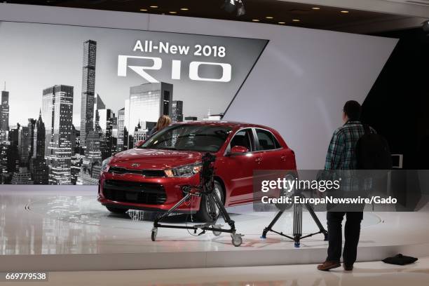 Man looks on at a display of the 2018 Kia Rio automobile during 2017 New York International Auto Show Press Day at Jacob K Javits Convention Center...