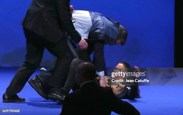 Militant of Femen who disturbed the campaign rally of French presidential candidate Marine Le Pen is removed by security at Zenith of Paris on April...