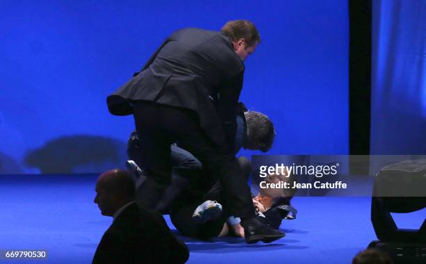 Militant of Femen who disturbed the campaign rally of French presidential candidate Marine Le Pen is removed by security at Zenith of Paris on April...