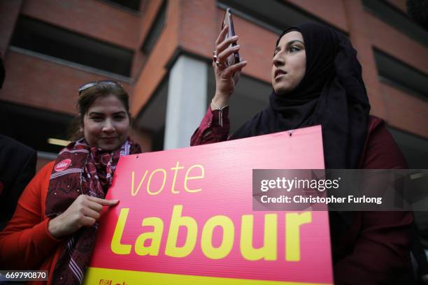 Labour supporters hold a sign saying "Vote Labour" as they wait for Labour leader Jeremy Corbyn to arrive at Birmingham Carers Hub to launch Labour's...
