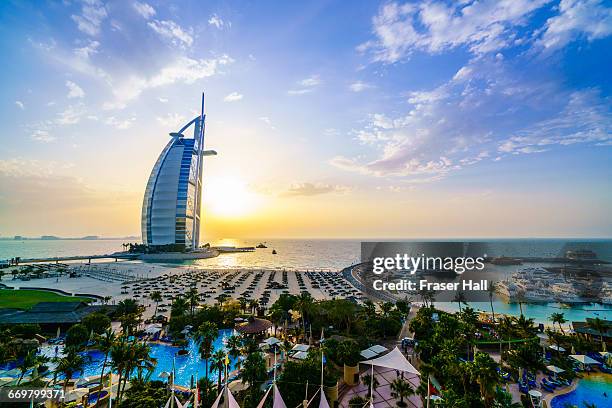 burj al arab at sunset, dubai - luxury location stock-fotos und bilder