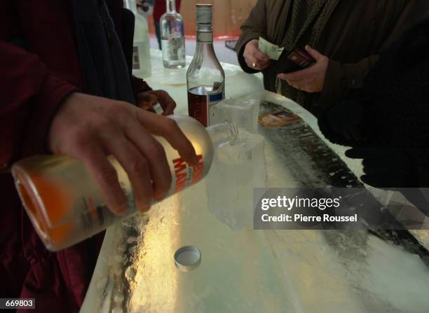 Bartender poors a shot of Vodka into a glass made of ice at the Absolut Ice Bar of the Ice Hotel Quebec-Canada January 7, 2001 in Quebec, Canada....