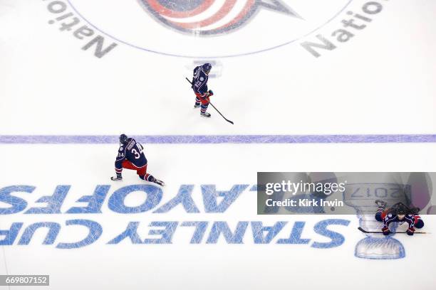 Josh Anderson, William Karlsson, and David Savard, all of the Columbus Blue Jackets, warm up prior to the start of Game One of the Eastern Conference...